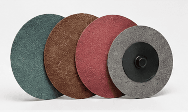 Assorted fiber discs in green, brown, maroon, and gray showing face and quick-change hub