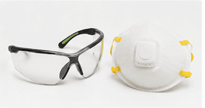 Safety glasses with clear wraparound lenses and a disposable dust mask with exhalation valve